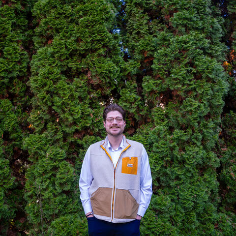 Frankie standing in front of trees